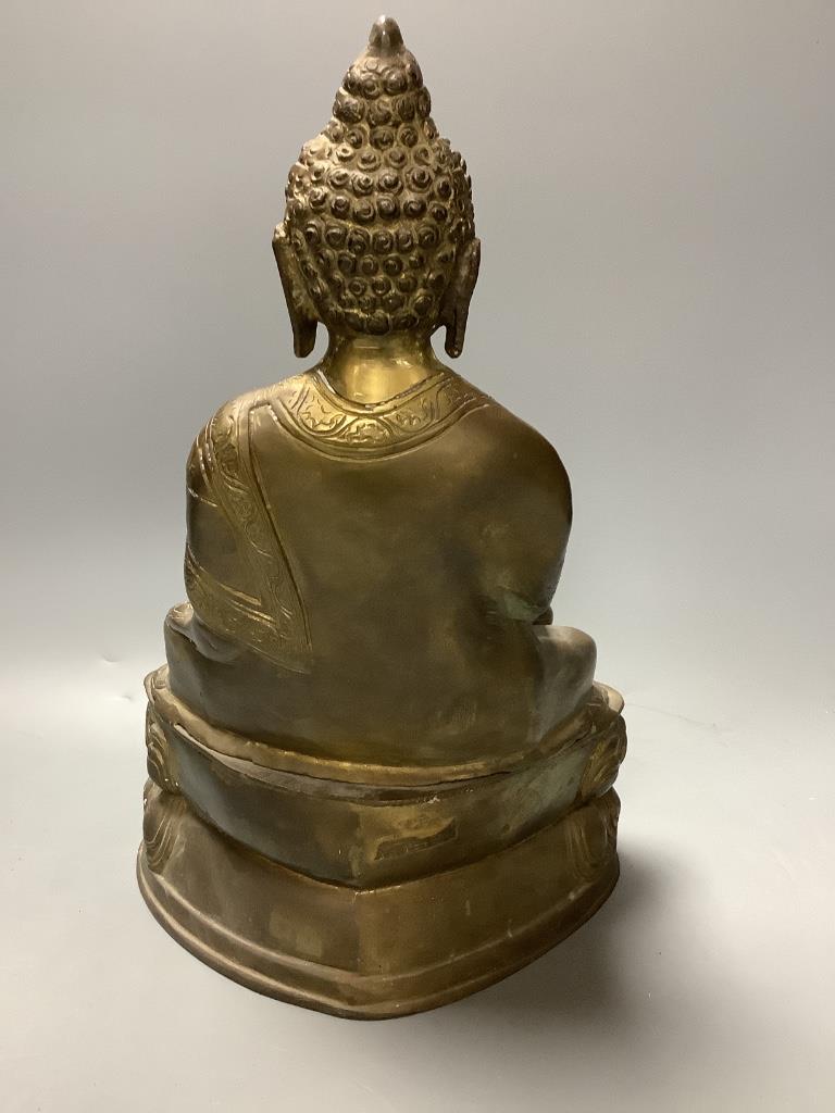 A bronze figure of a seated Buddha and a Japanese blue and white ovoid vase, of 'sack' form with applied tied cord and wavy rim, tallest 31cm H 30cm & 23cm